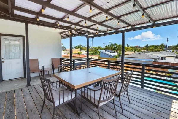 a view of a balcony with furniture and wooden floor