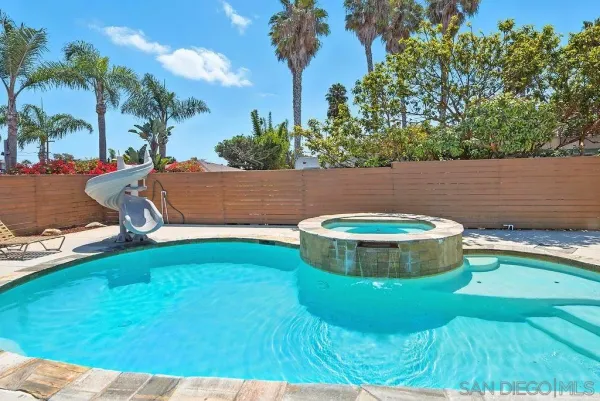 a view of a swimming pool with an outdoor space and seating area