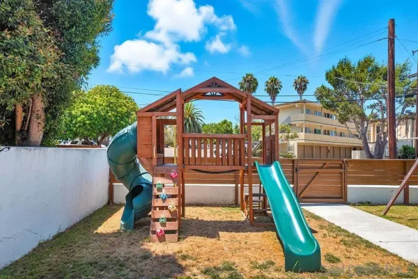 a view of a house with a wooden deck and a chair