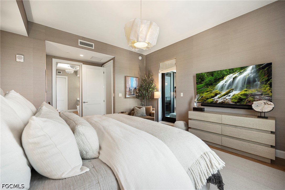 1115 Central Avenue, Unit 443 Naples, FL 34102 - Photo 22 of 40 a bedroom with a bed and a flat screen tv