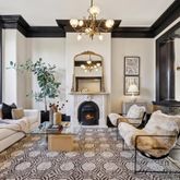 a living room with furniture a chandelier and a fireplace