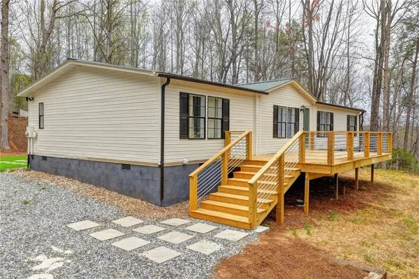 a view of a house with backyard and sitting area
