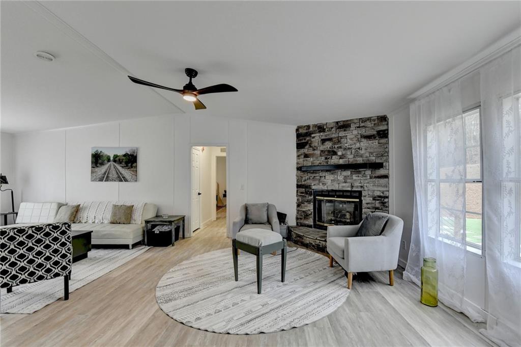 85 Betts Mine Road Dawsonville, GA 30534 - Photo 13 of 18 a living room with furniture and a chandelier