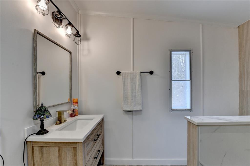 85 Betts Mine Road Dawsonville, GA 30534 - Photo 3 of 18 a bathroom with a sink and a mirror