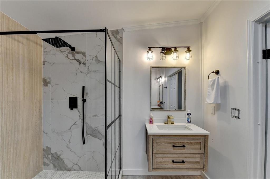 85 Betts Mine Road Dawsonville, GA 30534 - Photo 4 of 18 a bathroom with a sink vanity mirror and shower