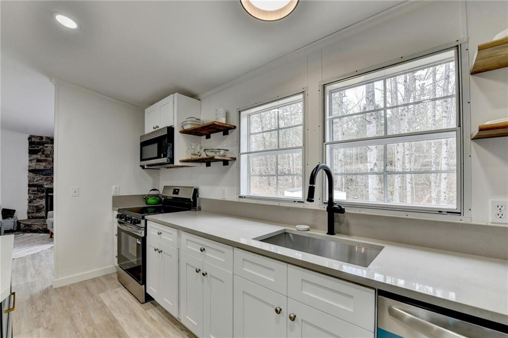 85 Betts Mine Road Dawsonville, GA 30534 - Photo 10 of 18 a kitchen with a sink cabinets and window