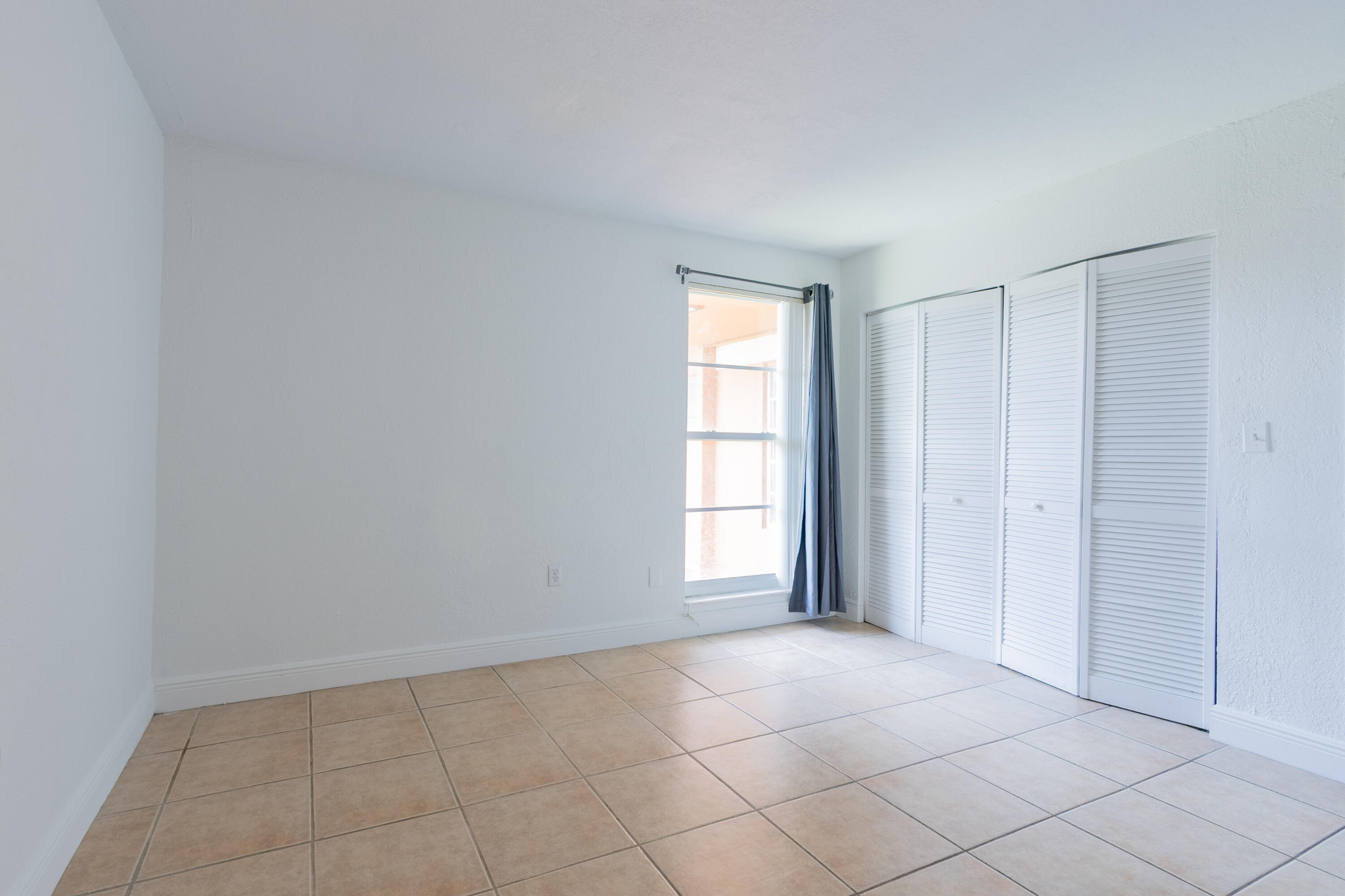 9459 Southwest 76th Street, Unit R8 Miami, FL 33173 - Photo 14 of 21 an empty room with windows