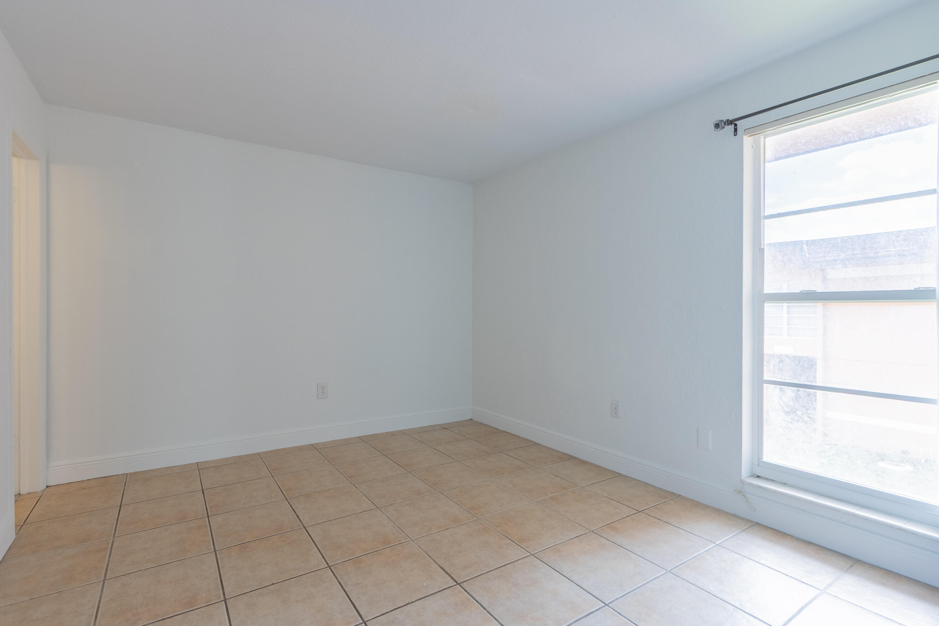 9459 Southwest 76th Street, Unit R8 Miami, FL 33173 - Photo 15 of 21 an empty room with a window