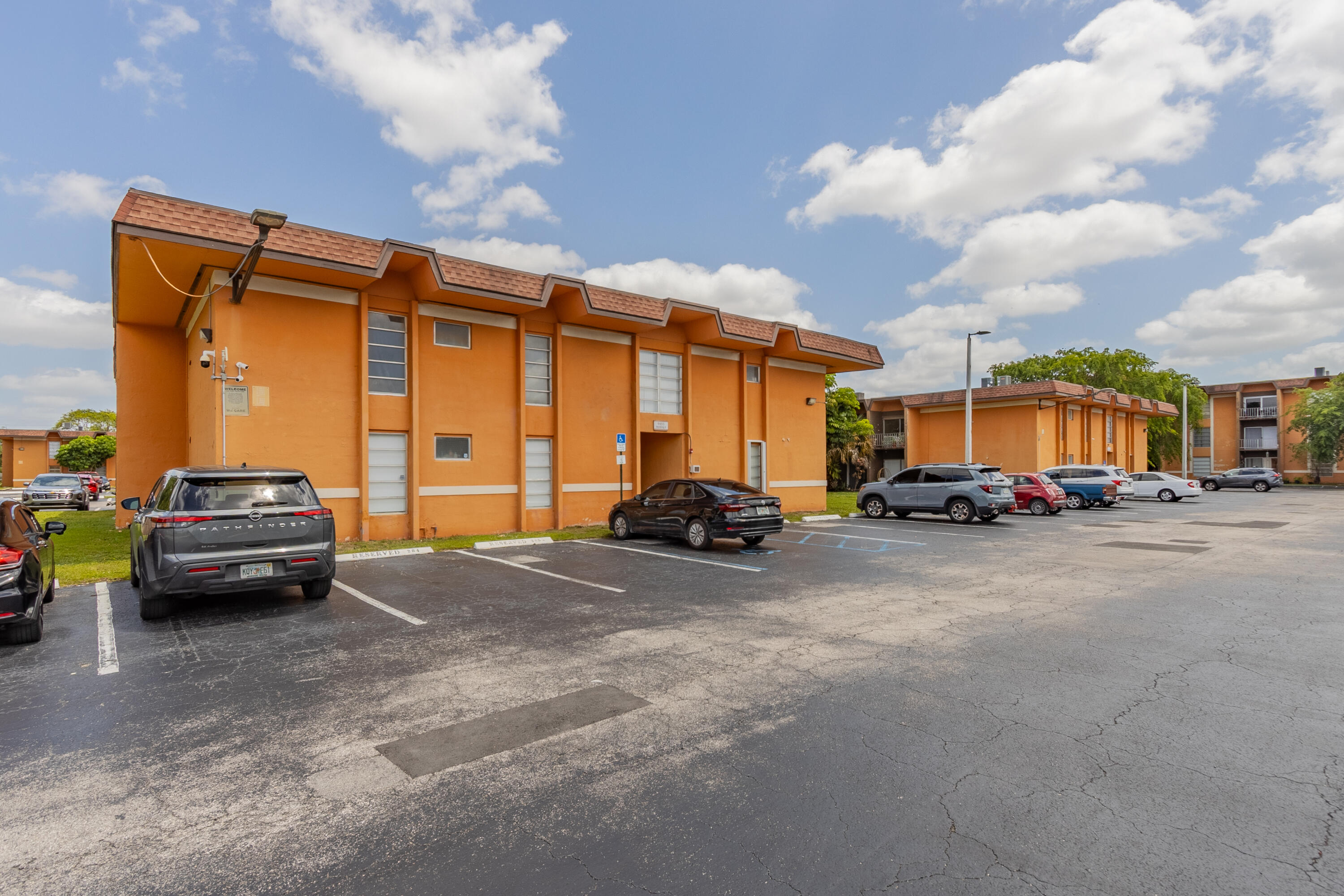 9459 Southwest 76th Street, Unit R8 Miami, FL 33173 - Photo 20 of 21 a view of outdoor space with porch and car parked
