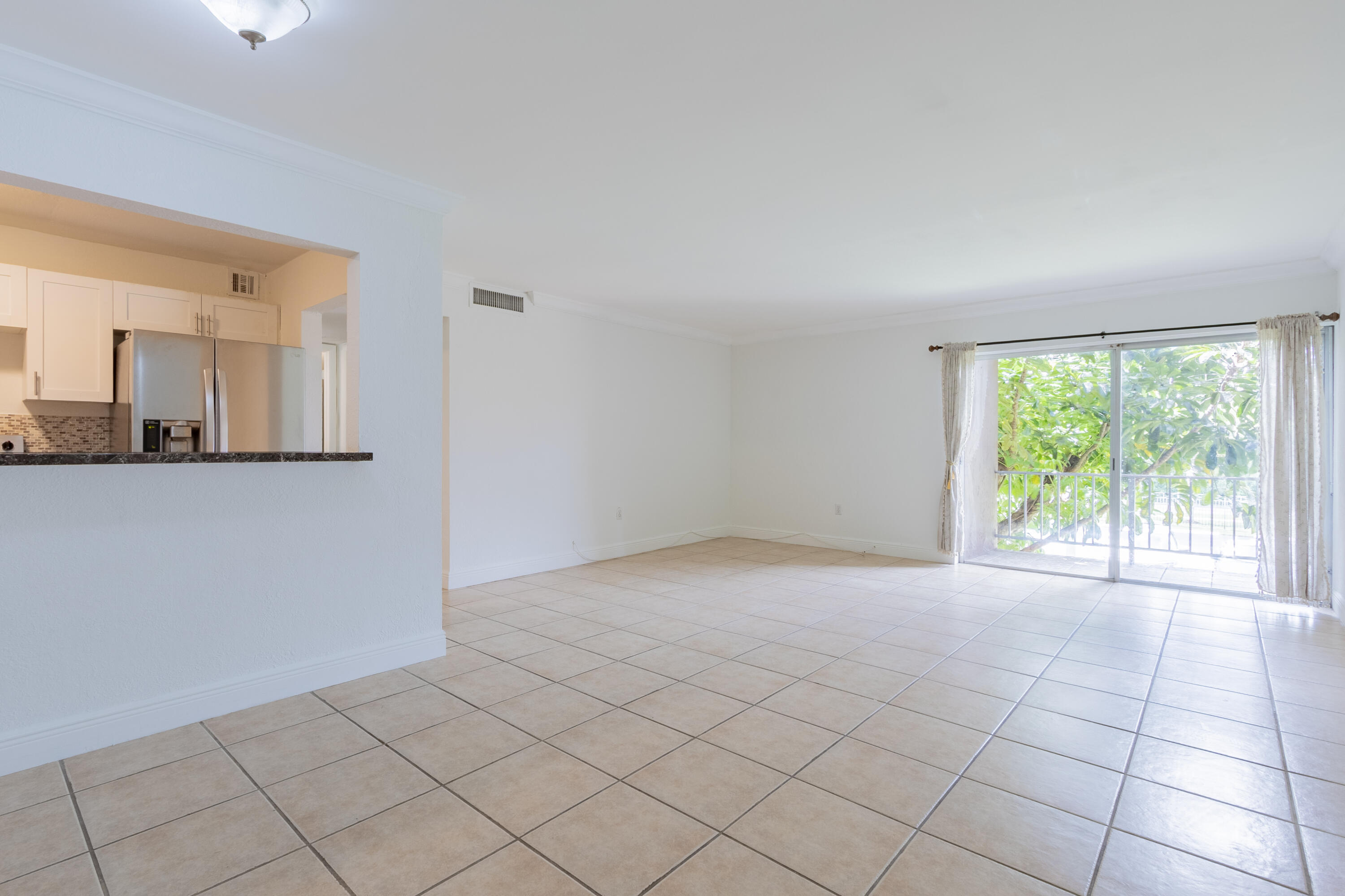 9459 Southwest 76th Street, Unit R8 Miami, FL 33173 - Photo 4 of 21 a view of an empty room with a window