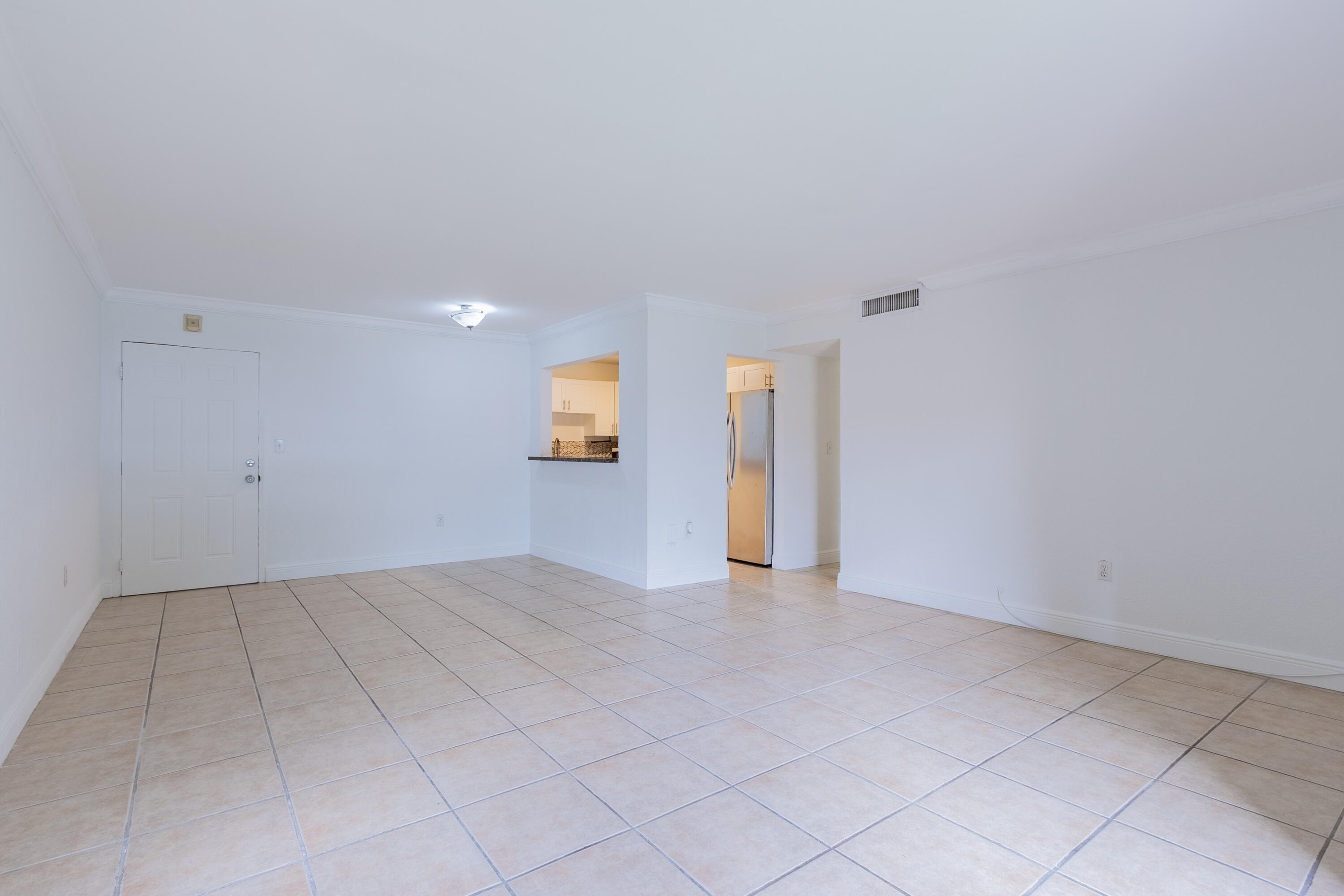 9459 Southwest 76th Street, Unit R8 Miami, FL 33173 - Photo 6 of 21 an empty room with entrance and windows