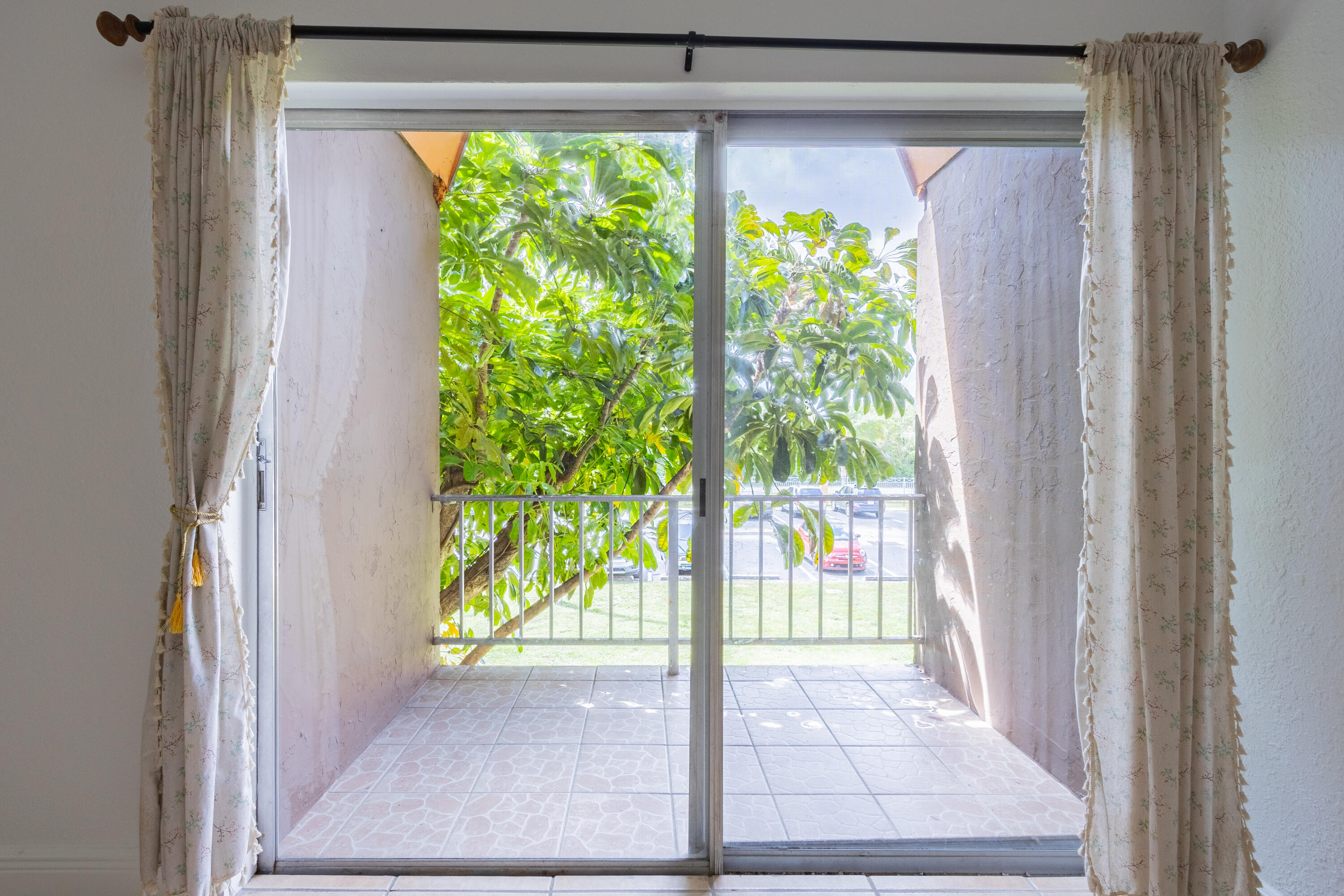 9459 Southwest 76th Street, Unit R8 Miami, FL 33173 - Photo 7 of 21 a view of a garden from a window