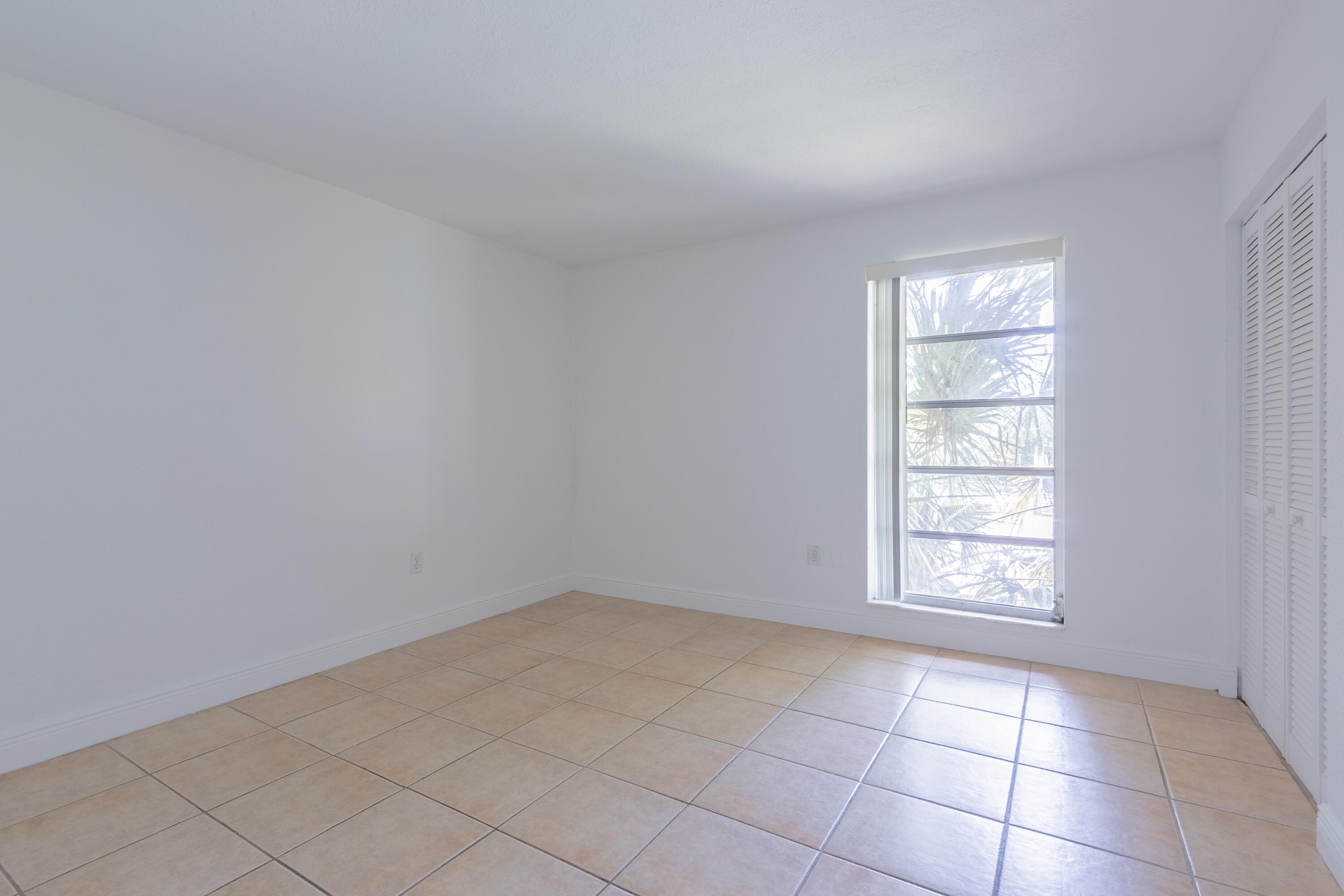 9459 Southwest 76th Street, Unit R8 Miami, FL 33173 - Photo 9 of 21 an empty room with windows