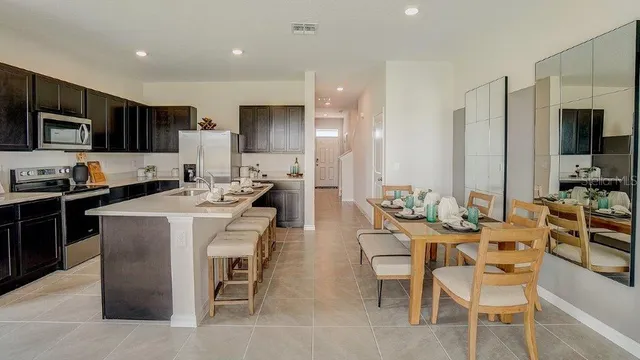 a large kitchen with a table and chairs