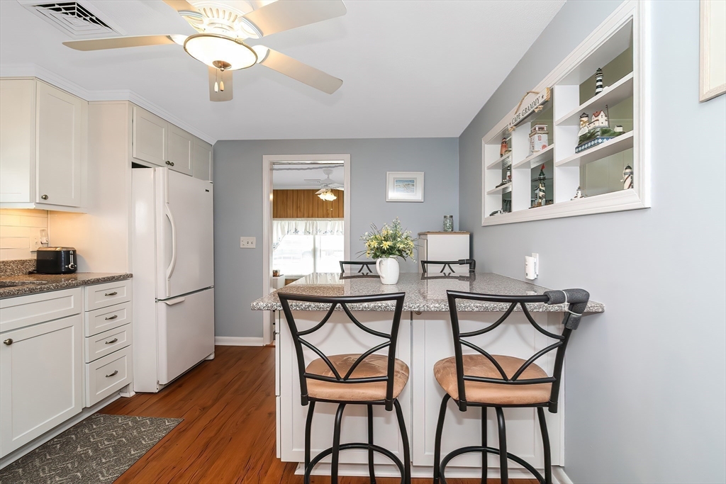 60 Security Street Barnstable, MA 02601 - Photo 11 of 32 a view of a dining room with furniture and chandelier