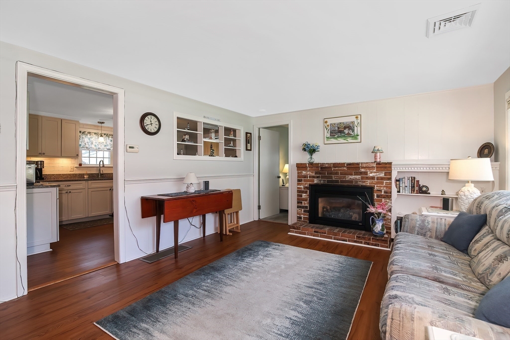 60 Security Street Barnstable, MA 02601 - Photo 15 of 32 a living room with furniture and a fireplace
