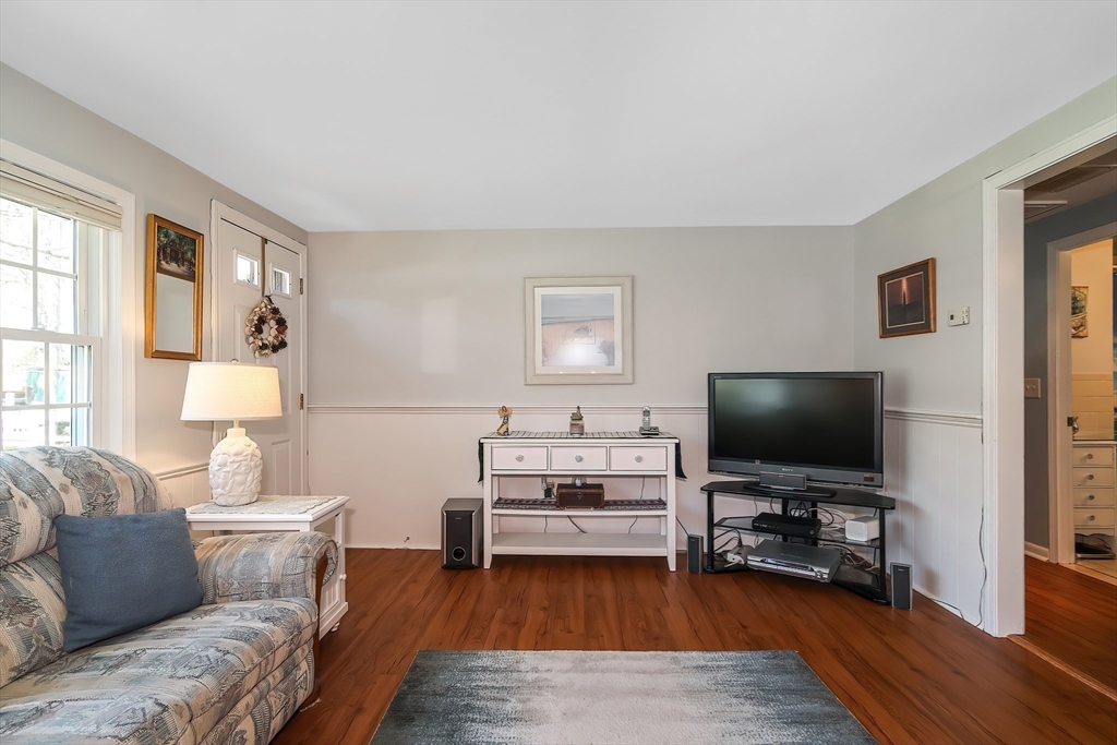 60 Security Street Barnstable, MA 02601 - Photo 16 of 32 a living room with furniture and a flat screen tv