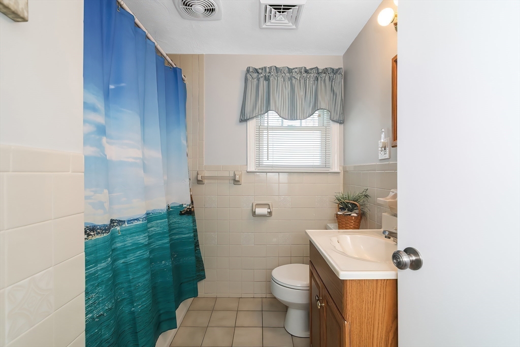 60 Security Street Barnstable, MA 02601 - Photo 20 of 32 a bathroom with a toilet a sink and a mirror