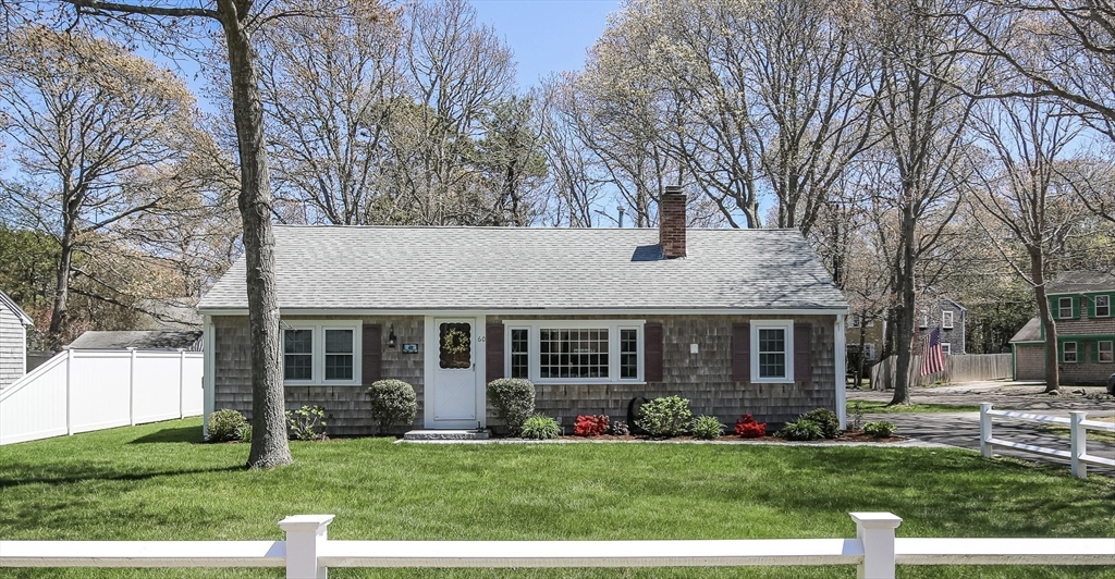 60 Security Street Barnstable, MA 02601 - Photo 2 of 32 a front view of a house with a yard