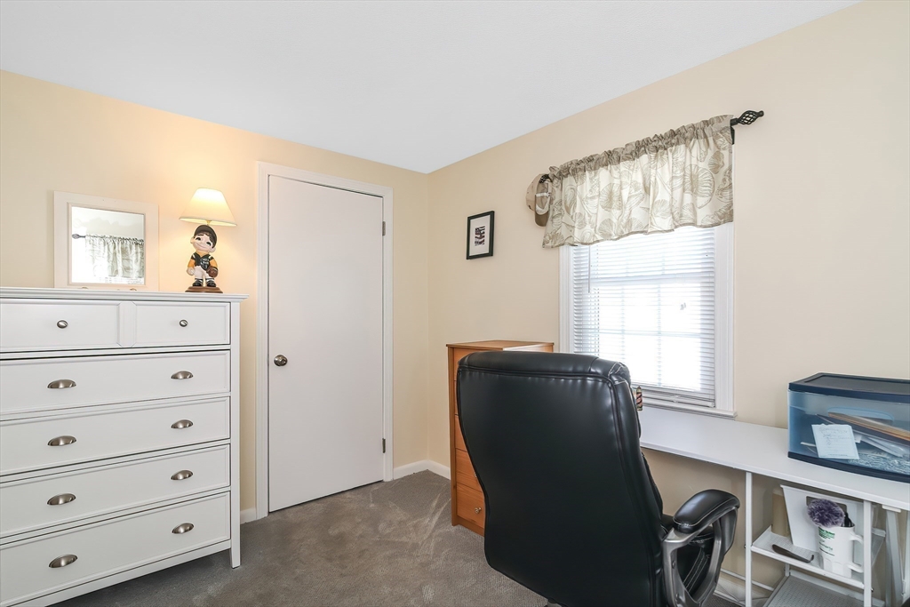 60 Security Street Barnstable, MA 02601 - Photo 22 of 32 a living room with a dresser and a window