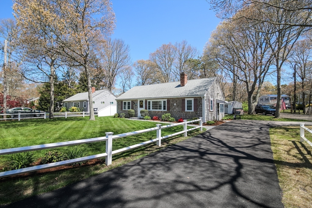 60 Security Street Barnstable, MA 02601 - Photo 5 of 32 a front view of a house with a yard
