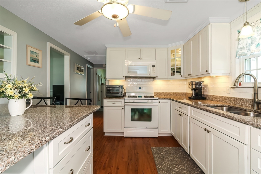 60 Security Street Barnstable, MA 02601 - Photo 9 of 32 a kitchen with sink stove and refrigerator
