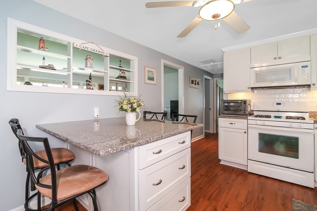 60 Security Street Barnstable, MA 02601 - Photo 10 of 32 a kitchen with a stove a sink and a refrigerator