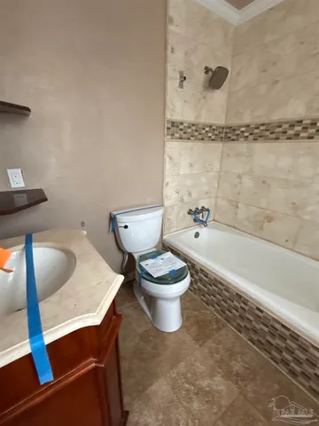 a bathroom with a toilet a sink and bathtub