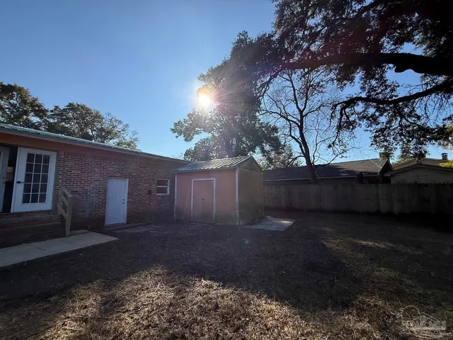 a view of backyard with plants and trees