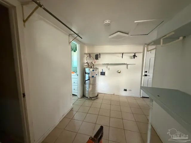 a view of a storage & utility room with a refrigerator