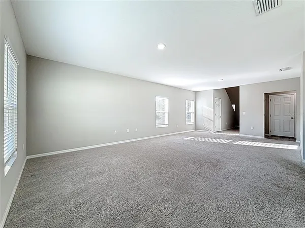a kitchen with cabinets wooden floor and stainless steel appliances
