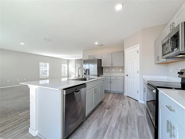 a kitchen with cabinets and stainless steel appliances