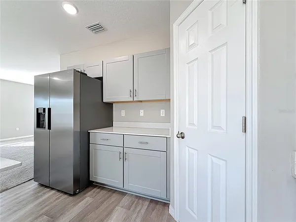 a kitchen with white cabinets and stainless steel appliances
