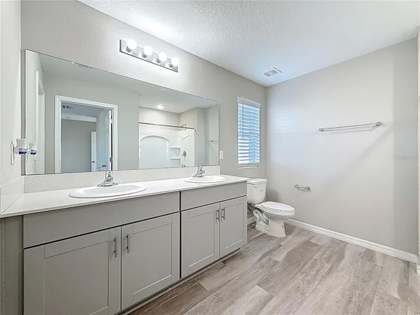 an empty room with windows and closet