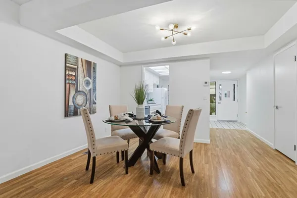 a view of a dining room with furniture and wooden floor