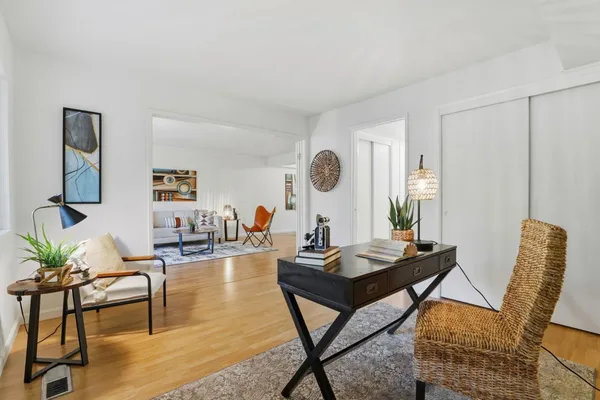 a living room with furniture and a wooden floor