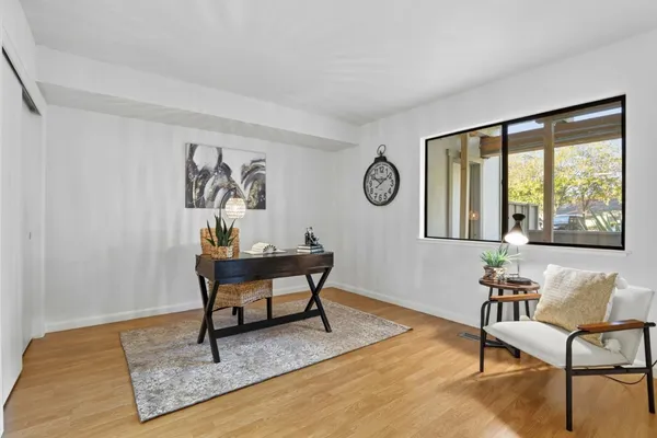 a living room with furniture a rug and a window