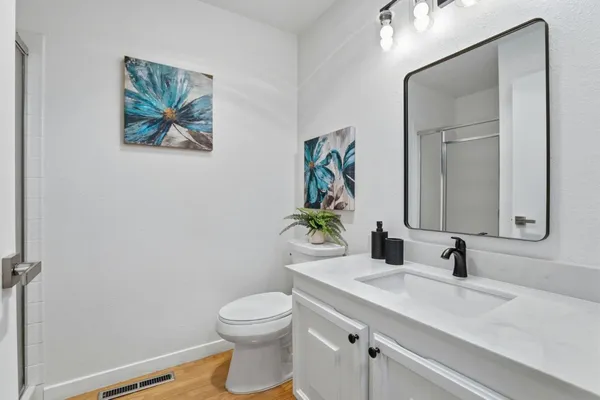 a bathroom with a toilet a sink and mirror