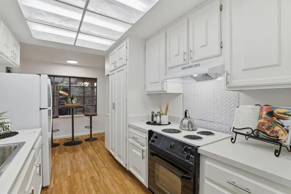 a kitchen with a stove and a refrigerator