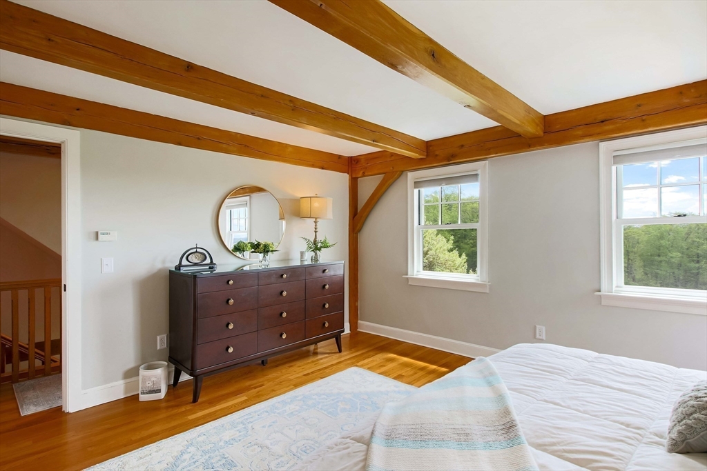 15 Allen Hill Road Princeton, MA 01541 - Photo 23 of 42 a bedroom with a bed and a dresser next to a window