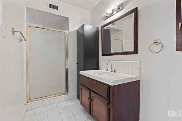 a bathroom with a sink vanity and a mirror
