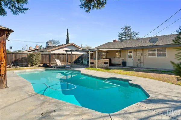 a front view of house with yard and swimming pool
