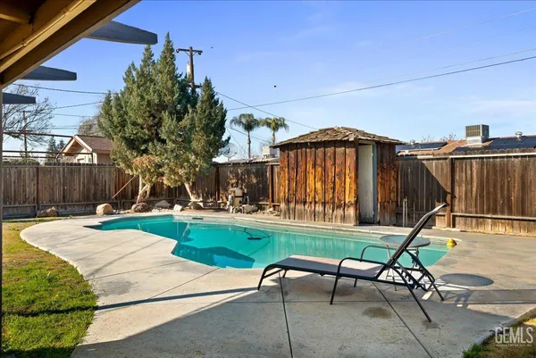 a view of a backyard with furniture and a garden