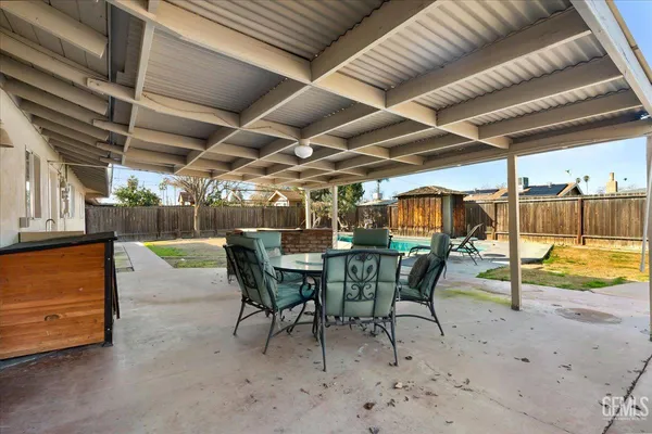 a view of a roof deck with table and chairs with wooden floor