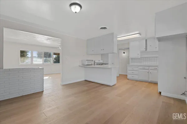 a view of a kitchen with refrigerator and cabinet