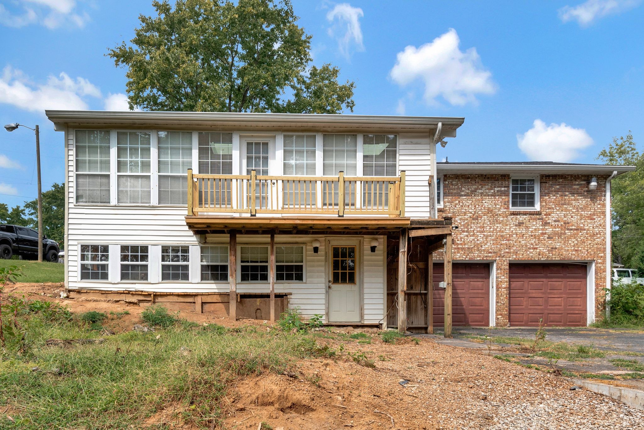 4848 Concord Drive Hermitage, TN 37076 - Photo 31 of 42 a view of a brick house with large windows and a large tree