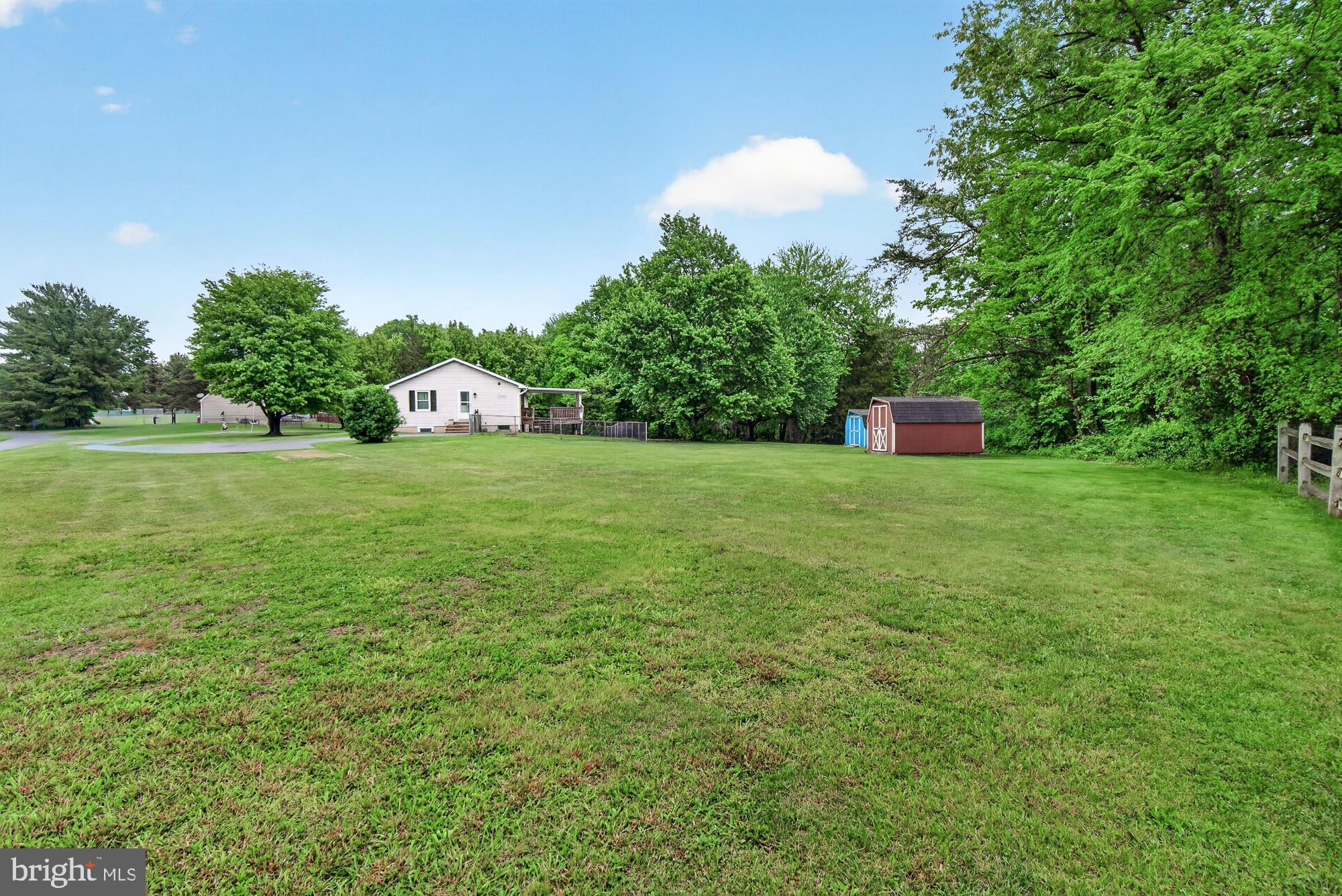 5601 Woodville Road Mount Airy, MD 21771 - Photo 47 of 54 a view of a house with a backyard and trees