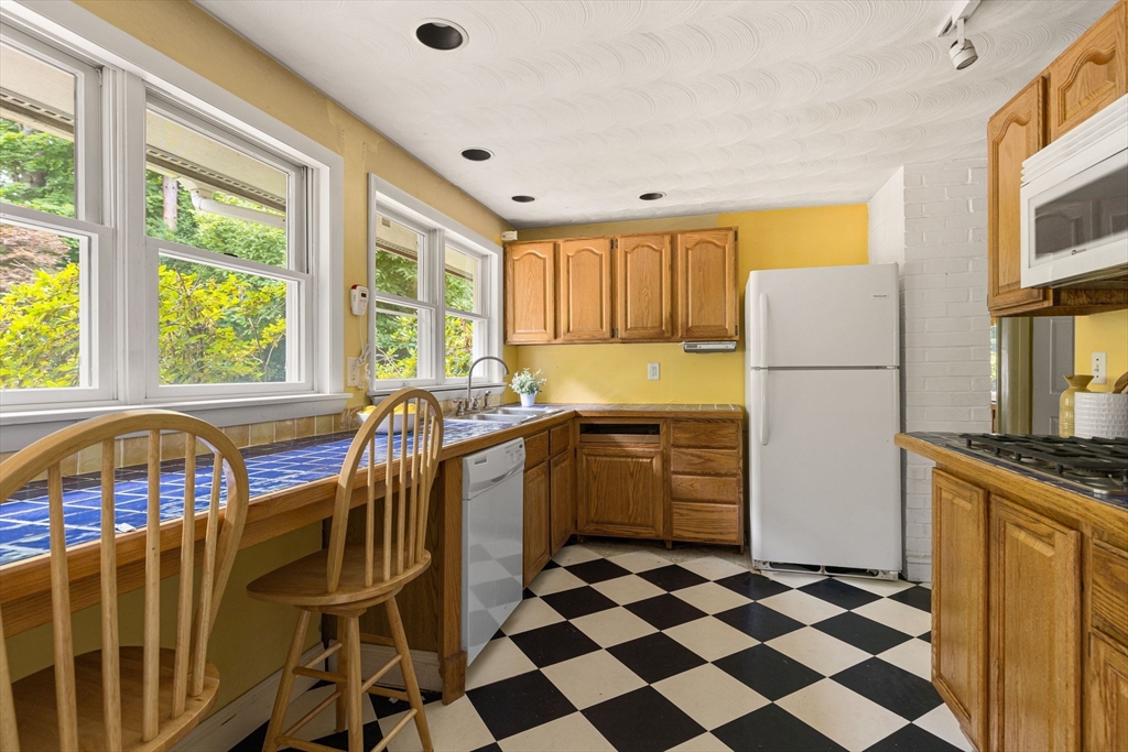 12 Janet Road Chelmsford, MA 01824 - Photo 8 of 21 a kitchen with a stove a sink and a refrigerator