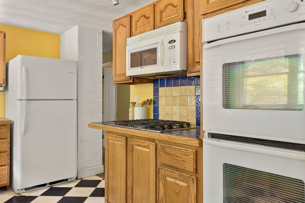 12 Janet Road Chelmsford, MA 01824 - Photo 10 of 21 a kitchen with stainless steel appliances granite countertop a refrigerator a stove and a microwave