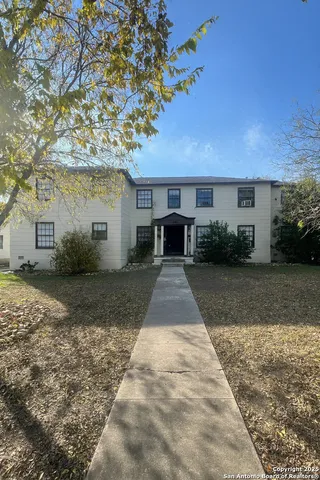 a front view of a house with a yard and a garage